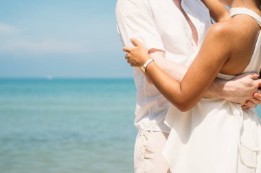 Happy couple embracing together and dancing on tropical beach, Lovers enjoying with honeymoon trip