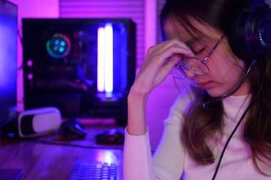 online game streamer feeling disappointed, Female gamer having eye strain and headache after lose game