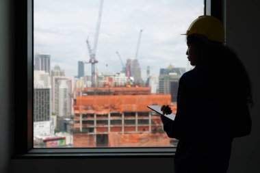 Female architect with tablet posing confident, Portrait of confident engineer foreman with safety helmet and vest on building site, Successful contractor smiling happily at workplace