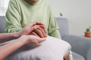 Close up hands of doctor touching senior patient hands reassuring and encouraging senior patient, Health care concept