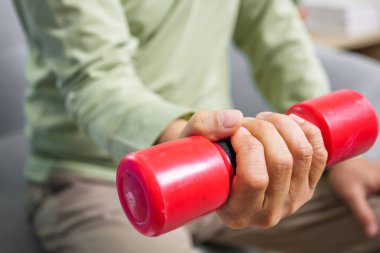Hand holding weight lifting close up, Senior people doing physical therapy after surgery operation, Elderly adult exercising by lifting weights at home, Medical treatment concept