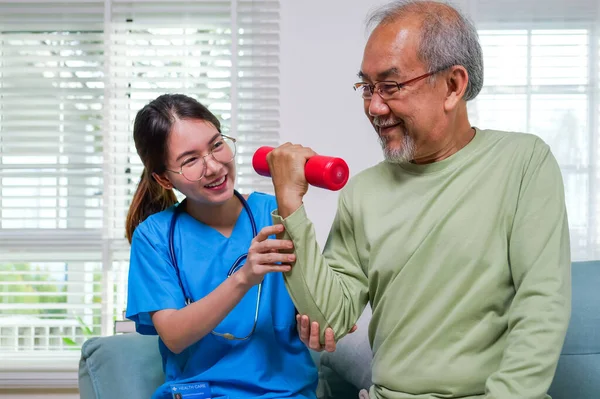 stock image Senior people doing physical therapy after surgery operation, Elderly adult exercising by lifting weights at home, Senior patient at living room, Medical treatment concept