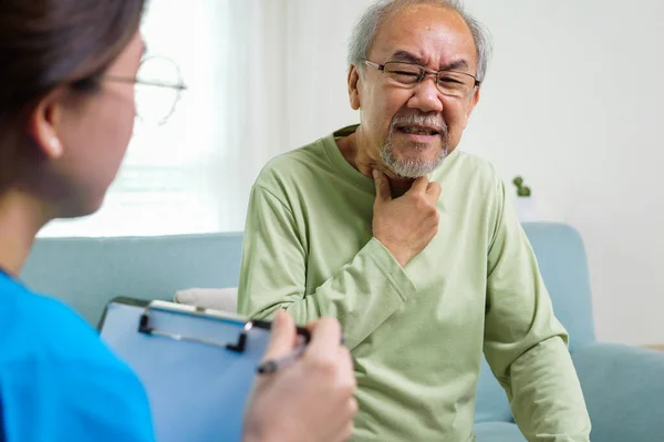 Young Doctor Examining Senior Patient Home Visit Senior Man Consulting Royalty Free Stock Photos
