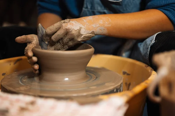 stock image Close up on skillful hands making and sculpting pottery jar on potter wheel with tools and water in workshop, Creative and artwork, Handmade craft