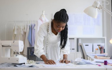 Happy female dressmaker working in workshop, Female tailor fashion designer checking measurements and fitting of dress, Tailoring clothing on mannequin garment workshop studio, Small business owner