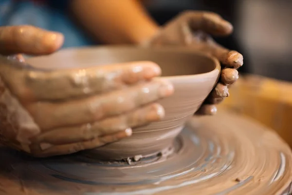 stock image Close up on skillful hands making and sculpting pottery jar on potter wheel with tools and water in workshop, Creative and artwork, Handmade craft