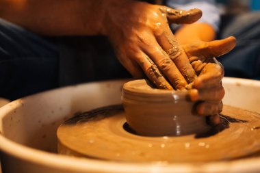 Professional craftsman potter making jug of clay on the potters wheel circle in workshop, Traditional handicraft working, Creativity and art of pottery