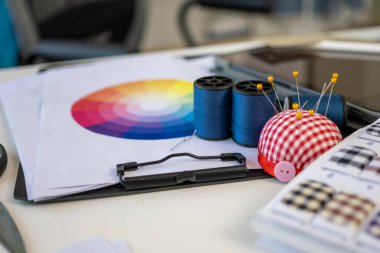 Sewing machine and accessories on table at dressmaking workshop, Dressmaker working in workshop, Tailor fashion designer checking measurements and fitting of dress, Small business owner