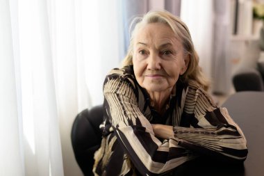 Smiling portrait of happy senior woman smiling and sitting on sofa at home, Happy retirement people relaxing and resting at home, Healthy and happy senior people concept