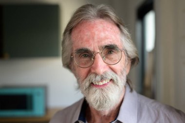 Portrait of healthy senior man with red cup of tea, Retirement man resting and relaxing at home