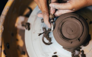 Professional craftsman potter making jug of clay on the potters wheel circle in workshop, Traditional handicraft working, Creativity and art of pottery