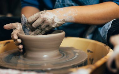Professional craftsman potter making jug of clay on the potters wheel circle in workshop, Traditional handicraft working, Creativity and art of pottery