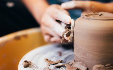 Professional craftsman potter making jug of clay on the potters wheel circle in workshop, Traditional handicraft working, Creativity and art of pottery