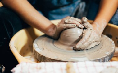 Professional craftsman potter making jug of clay on the potters wheel circle in workshop, Traditional handicraft working, Creativity and art of pottery