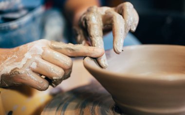 Professional craftsman potter making jug of clay on the potters wheel circle in workshop, Traditional handicraft working, Creativity and art of pottery