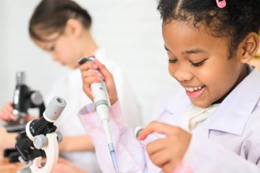 Okula geri dönüş, çocukların eğitim bilgisi, okulda sınıfta bir çocuk, Fen laboratuarı önlüğü giymiş çocuk, okul konseptinde fen bilgisi.