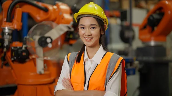 Asian engineer portrait, Confident female industrial engineer with safety uniform protection crossing arms smiling to camera, Engineer portrait concept, Asian Female manager engineer concept