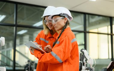 Engineer technician with protective uniform operating in training program, Specialist checking and testing automatic machine
