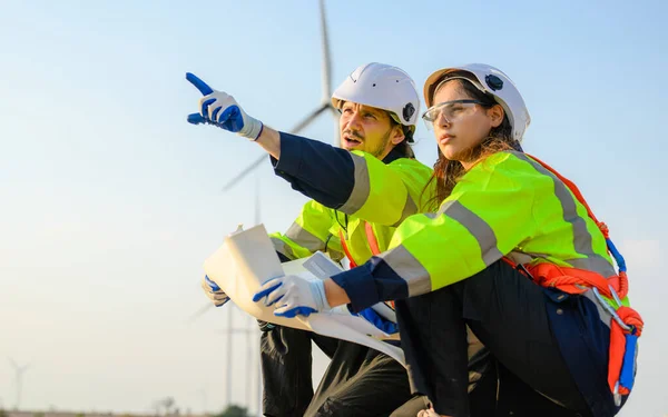 Engineer technician with safety uniform working at wind turbine field, Environmental engineer researching and developing clean energy sources, Green ecological power energy