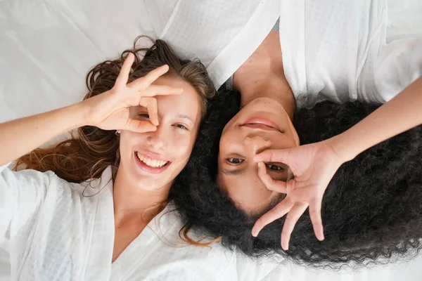 Cheerful close friends women expressing happy face with smile to camera, Indoor photo of two friends women posing to camera with happiness, Sincere love between people