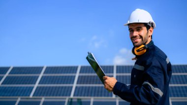 Engineer worker portrait with solar panel at solar farm, Solar farm with engineer workers analyzing solar cell, Renewable energy engineers work production of energy renewable or sustainable source