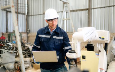 Engineer technician controlling robotic arms on computer laptop, Software mechanic control machine