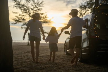 Happy Asian family travel together on beach on holiday. Family with beach travel. People enjoying with holiday vacation. High quality photo