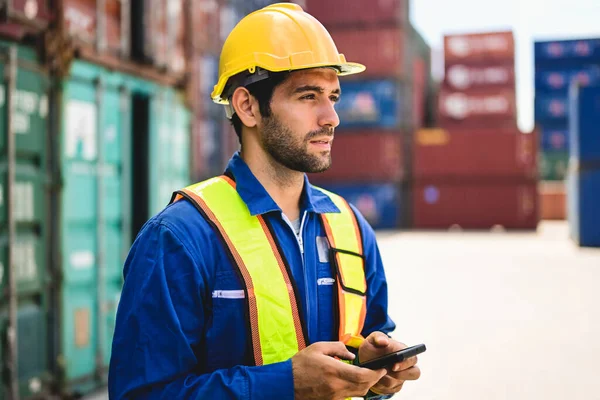 stock image Professional industrial engineer worker working at overseas shipping container cargo yard, Logistics supply chain management, International good import and export