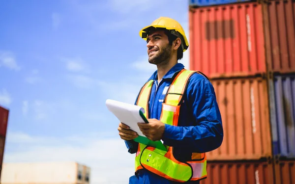 stock image Professional industrial engineer worker working at overseas shipping container cargo yard, Logistics supply chain management, International good import and export