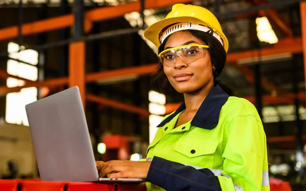 Portrait of happy female maintenance engineer checking and controlling machine at factory, Mechanic worker checking and inspecting machine at manufacturing factory, Machinery maintenance concept, High