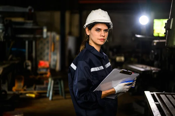 Confidence female mechanical engineer manager checking and inspecting engine machine at factory, Mechanic worker working at manufacturing factory, Machinery maintenance concept, High quality photo