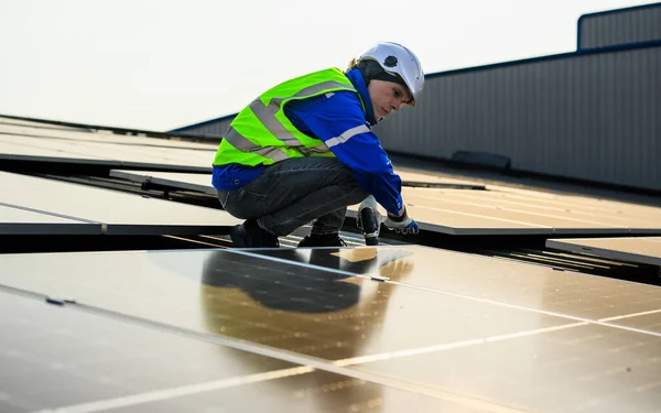 stock image Professional engineer technician with safety helmet working with solar power station, Worker with solar energy at industrial solar power farm