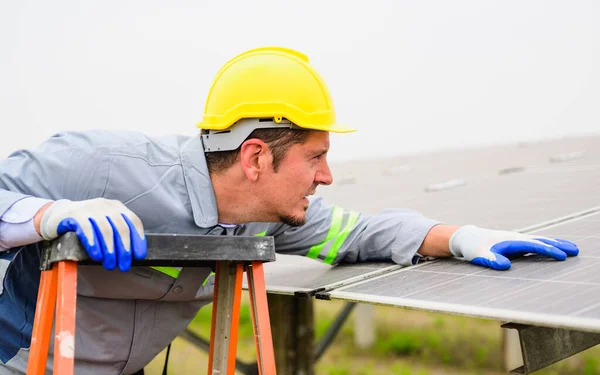 stock image Professional engineer checking and maintaining solar panels on solar cell farm, Technician working on ecological solar farm, People with clean energy technology, Renewable energy, Solar power plant