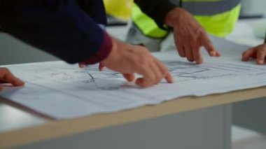 Professional construction engineers team using blueprint of project plan brainstorming and working together at construction building, Architecture and building construction concept