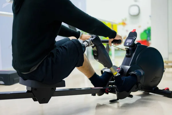 Male patient with physical disability doing exercise routine indoor, People with high tech technology at prosthetic health care center, New artificial limb production for disabled people