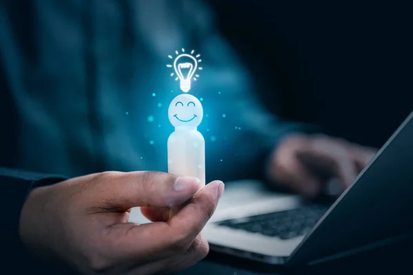 Hands holding wooden doll employee and light bulb icon, Technology and innovation, Employee with teamwork, Intelligent thinking, Creative and idea concept
