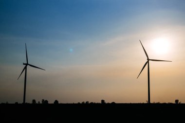 Windmill park with clouds and a blue sky, Wind turbine field, Green ecological power energy generation wind sustainable energy concept, High quality photo