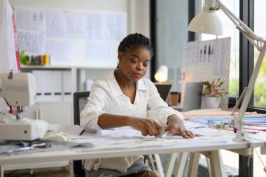 Mutlu terzi tasarımcısı atölyede çalışıyor, kadın terzi moda tasarımcısı ölçüleri ve kıyafet provalarını kontrol ediyor, manken giyimi atölyesinde terzilik yapıyor, küçük işletme sahibi.