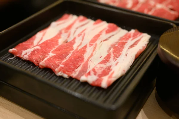 stock image Slide beef in black plate, Slide of beef, Beef and hotpot at restaurant, Slide raw beef