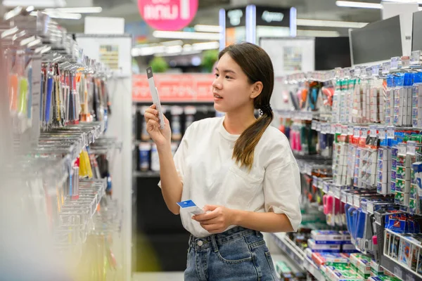 stock image young woman enjoying shopping at department store. High quality photo