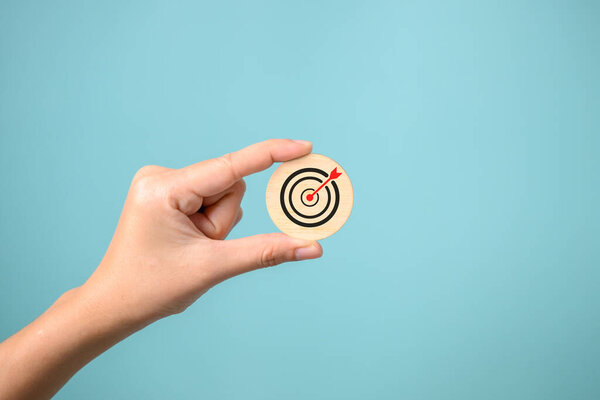 Hand putting business icons on wooden cubic blocks, Business cooperation, Business goal icons, Financial business chart planning project, Target management