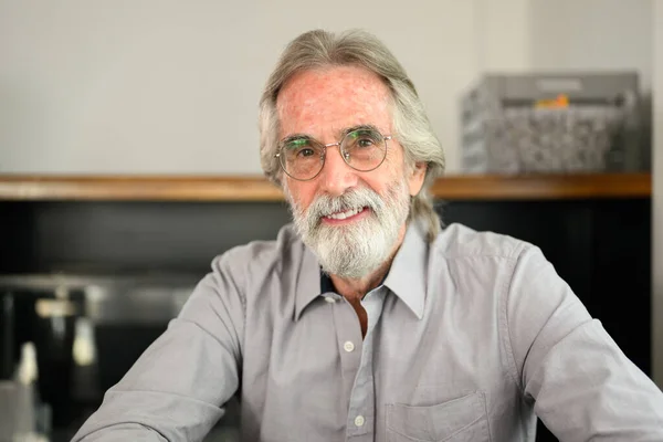 stock image Happy senior man with eyeglasses looking at camera portrait, Grandfather resting and relaxing at home, Happy retired man at home