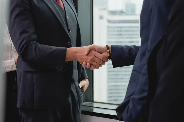 Business people shacking hands together showing successful contract agreement in meeting room, Business officer clapping hands with gladness in comfortable modern office room