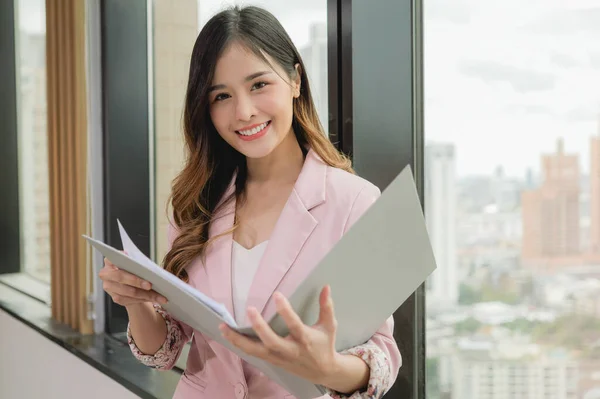 Portrait of businesswoman working in modern office, Confident female business officer looking at camera with smile in conference room for business corporation meeting