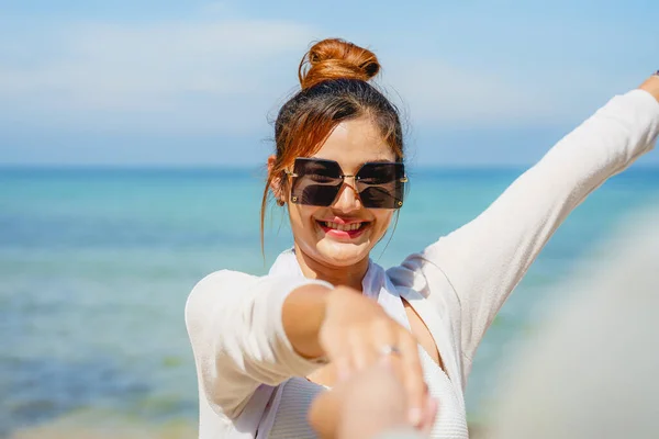 Stock image Portrait of young woman looking at camera with smile, Beautiful woman strolling along beach with happiness, Beach travel concept