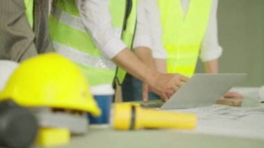 Group of professional civil engineers team working on new building at construction site, Contractor talking and assigning work to workers, Engineering and architecture concept