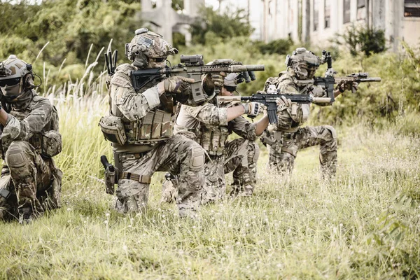 stock image Smart teamwork of soldiers running forward and attacking enemy during military operation, Army soldiers in protective combat uniform, Soldiers with rifle, Soldiers with rifle on world war field