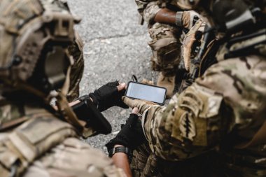 Askeri harekat sırasında ileri doğru koşan ve düşmana saldıran askerlerden oluşan akıllı bir ekip. Koruyucu savaş üniformalı askerler, tüfekli askerler, savaş meydanında tüfekli askerler.