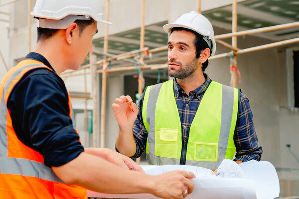 Civil engineers team with safety hard hat working together at construction site outdoor, Construction workers checking and controlling project on building site, Architecture engineering on new project