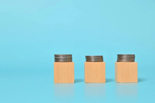 stock image Rows of coins on wooden cubes, Financial business investment, Growing money, People saving money, Money saving and financial banking. High quality photo